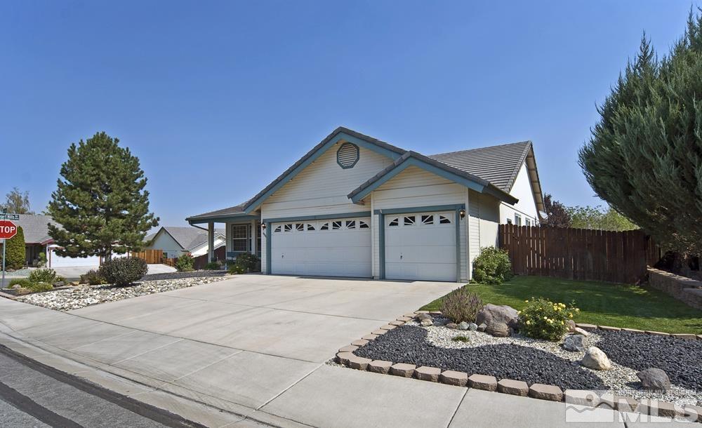 4505 Goodwin Road Sparks, NV 89436 - Photo 5 of 38 a front view of a house with a yard and garage