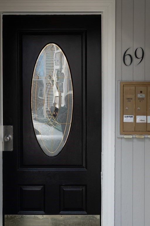 69 I Street, Unit 3 Boston, MA 02127 - Photo 13 of 14 an view of wooden door with a glass door and a mirror