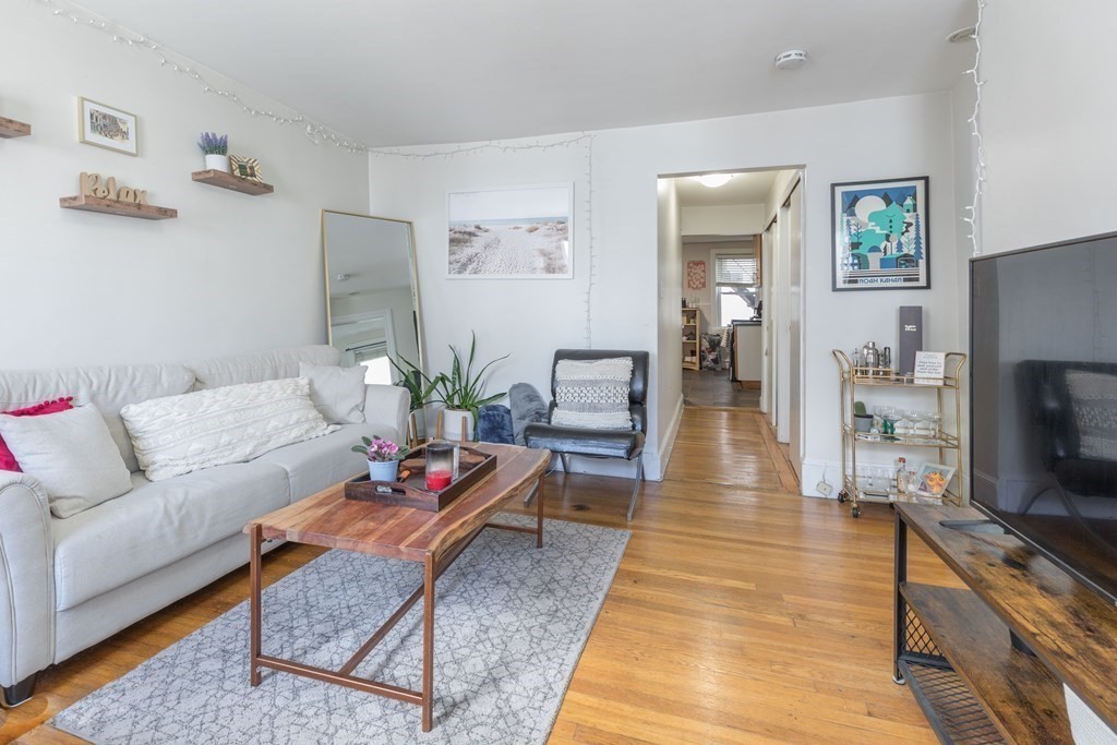 69 I Street, Unit 3 Boston, MA 02127 - Photo 3 of 14 a living room with furniture and a flat screen tv
