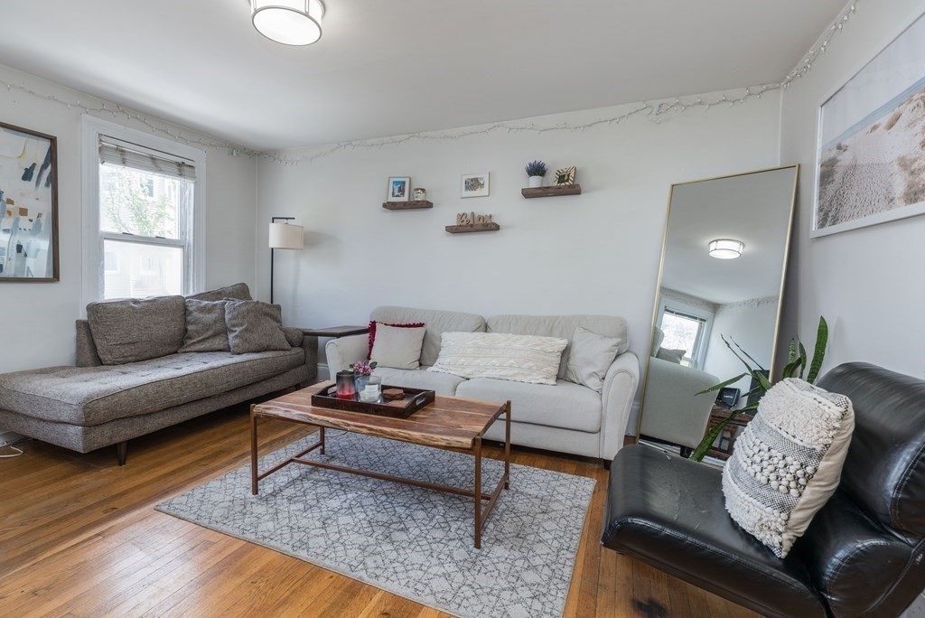 69 I Street, Unit 3 Boston, MA 02127 - Photo 4 of 14 a living room with furniture rug and window