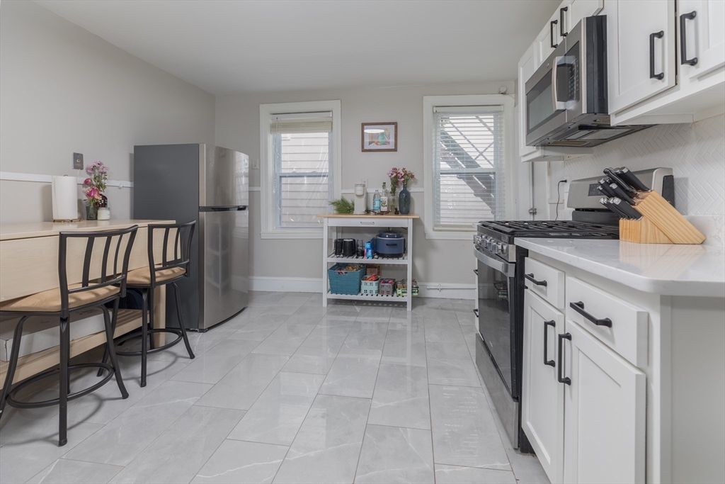 69 I Street, Unit 3 Boston, MA 02127 - Photo 5 of 14 a kitchen with cabinets and furniture