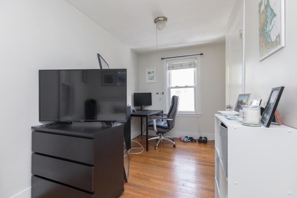 69 I Street, Unit 3 Boston, MA 02127 - Photo 10 of 14 a view of a workspace with furniture and a window