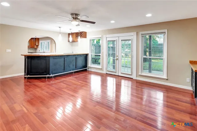 a kitchen with a sink cabinets and wooden floor