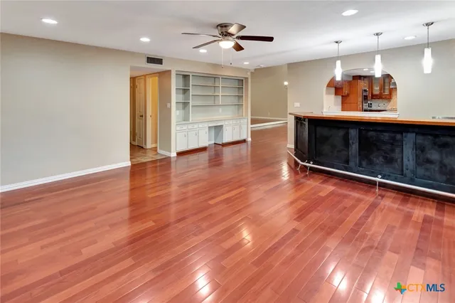 a living room with wooden floors and a fireplace