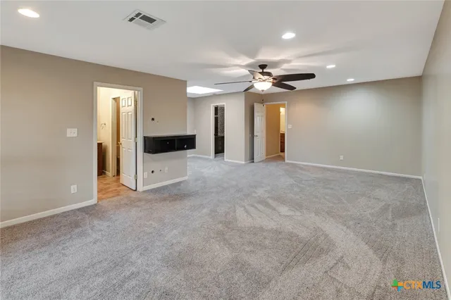 an empty room with closet and entrance