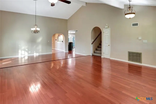 a view of a room with wooden floor