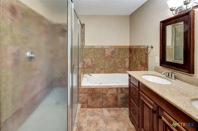 a bathroom with a granite countertop sink mirror toilet and bathtub