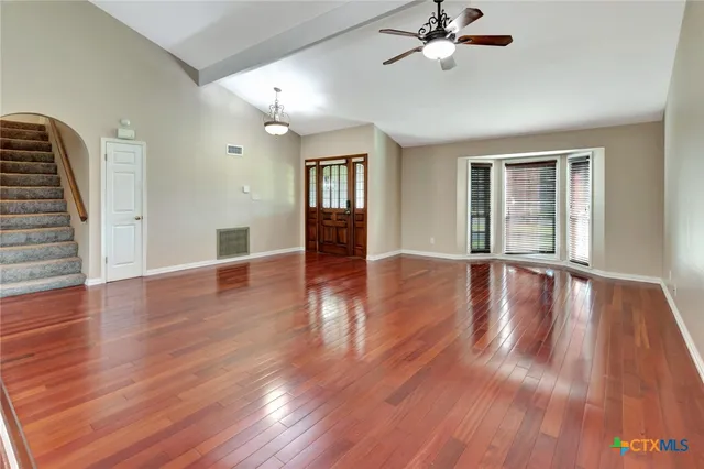 wooden floor in an empty room with a window