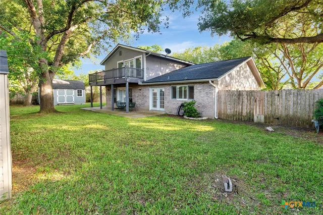 a view of a patio with a table chairs and a backyard