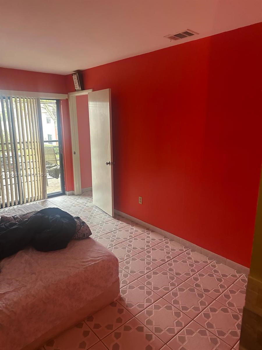 855 Northeast 209th Street, Unit 20334 Miami, FL 33179 - Photo 11 of 17 a bedroom with a bed and a window