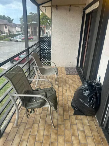 a view of a balcony with chairs