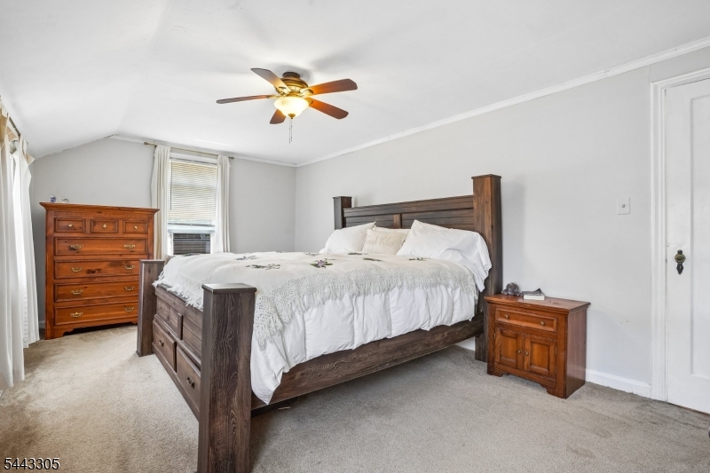 267 Kings Road Madison, NJ 07940 - Photo 19 of 37 a bedroom with a bed and a ceiling fan
