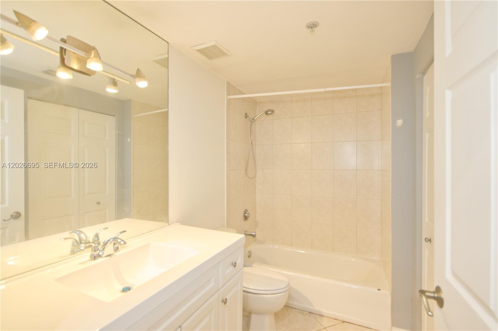 2630 Southwest 28th Street, Unit 22 Miami, FL 33133 - Photo 4 of 9 a bathroom with a sink a toilet and shower