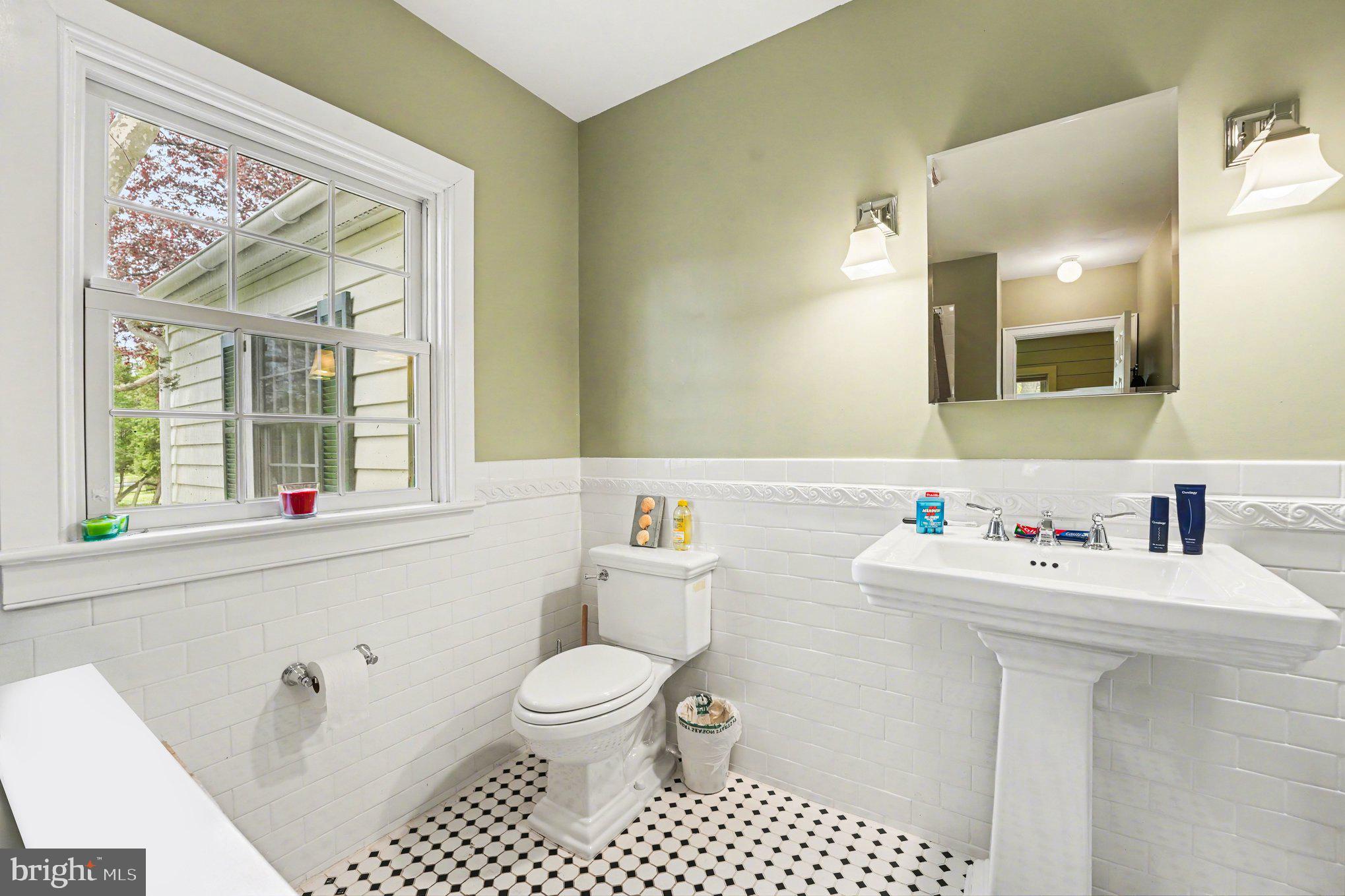 2723 Mill Road Doylestown, PA 18902 - Photo 23 of 39 a bathroom with a sink a toilet and a mirror