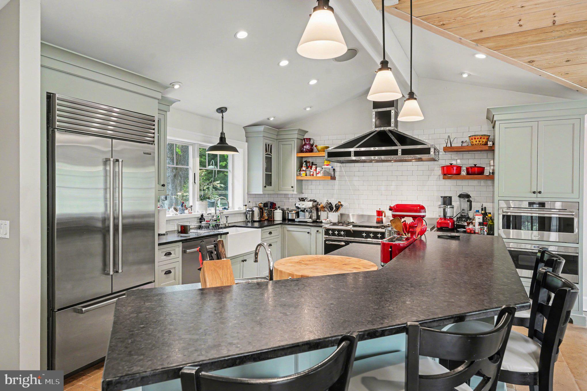 2723 Mill Road Doylestown, PA 18902 - Photo 6 of 39 a kitchen with a dining table chairs and refrigerator