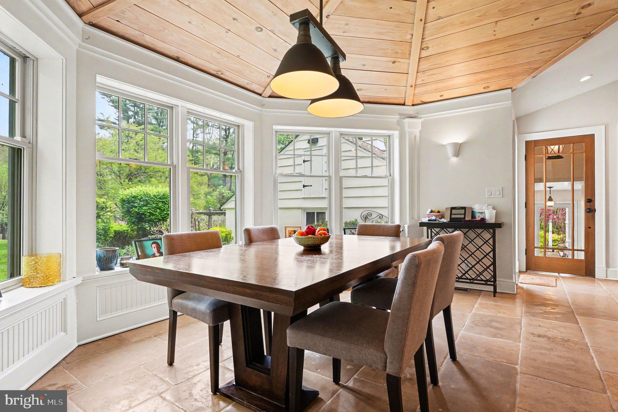 2723 Mill Road Doylestown, PA 18902 - Photo 8 of 39 a dining room with wooden floor a chandelier a wooden table and chairs
