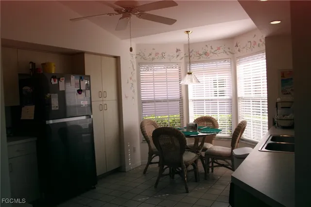 a view of a dining room with furniture and window