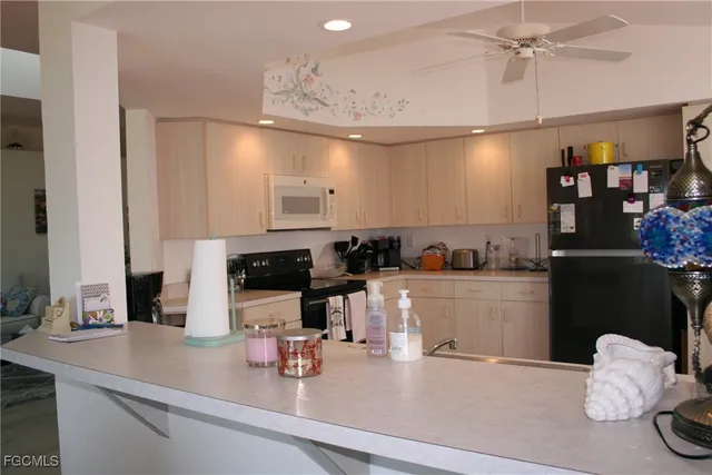 a kitchen with a sink and chandelier
