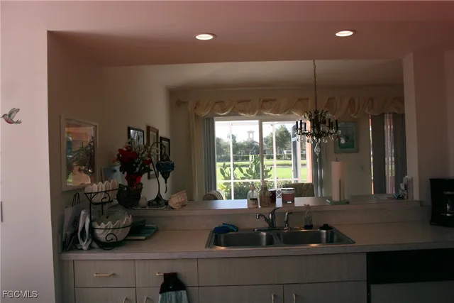 a kitchen with a sink and a large window