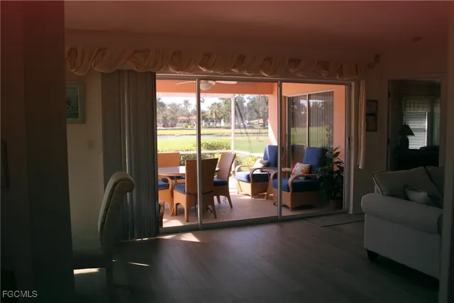 a living room with furniture and a floor to ceiling window