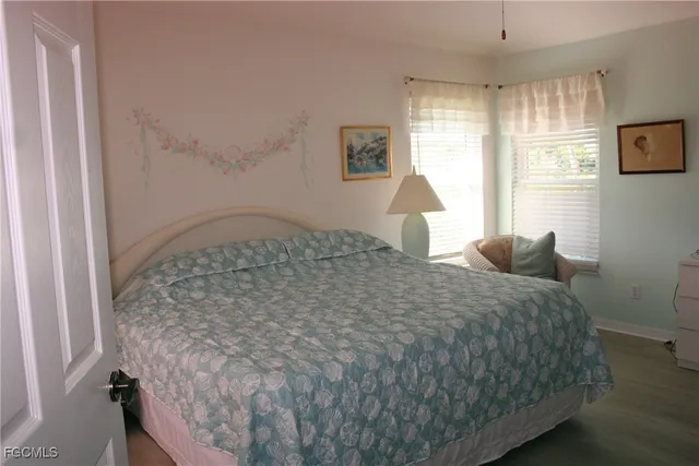 a large bed sitting in a bedroom next to a window