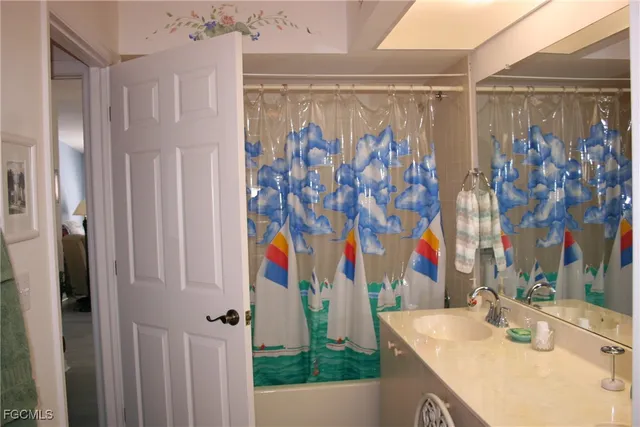 a bathroom with a shower curtain and a sink