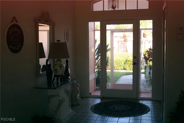 a living room with furniture and a floor to ceiling window