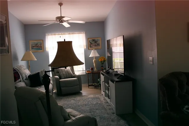 a living room with furniture and a lamp