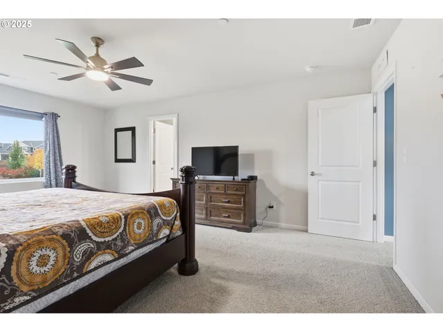 a bedroom with a bed and a tv