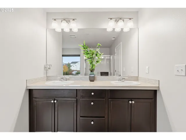 a bathroom with a granite countertop sink a large mirror and a