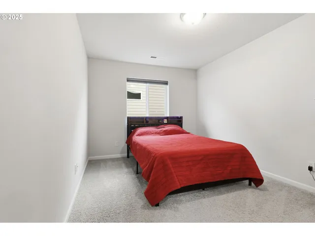 a bedroom with a bed and a night stand