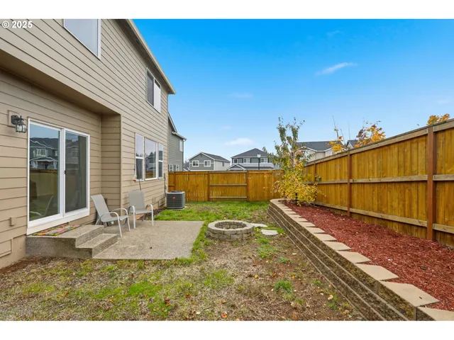 a view of a backyard with sitting area
