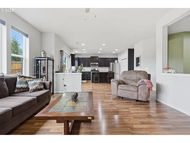 a living room with furniture and kitchen view