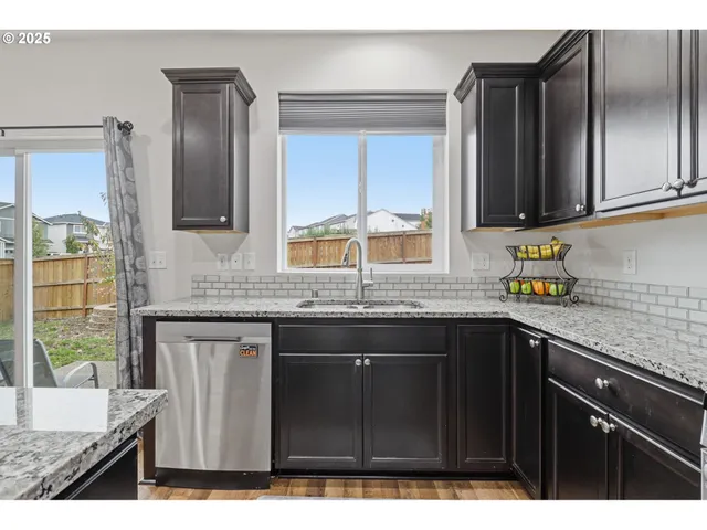 a kitchen with granite countertop a sink and a stove