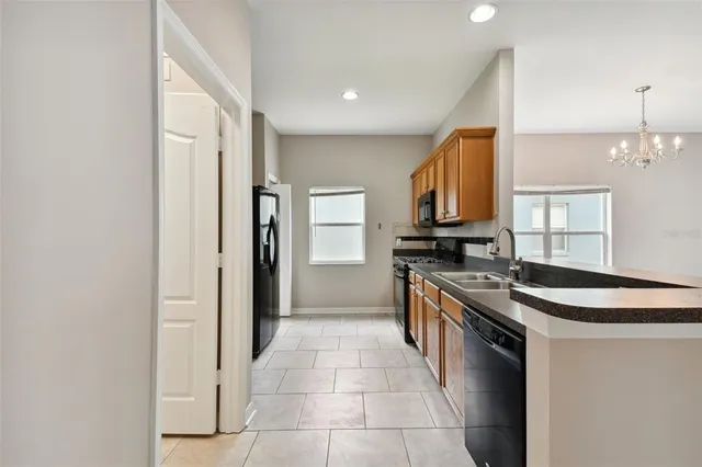 a kitchen with stainless steel appliances granite countertop a sink and a stove