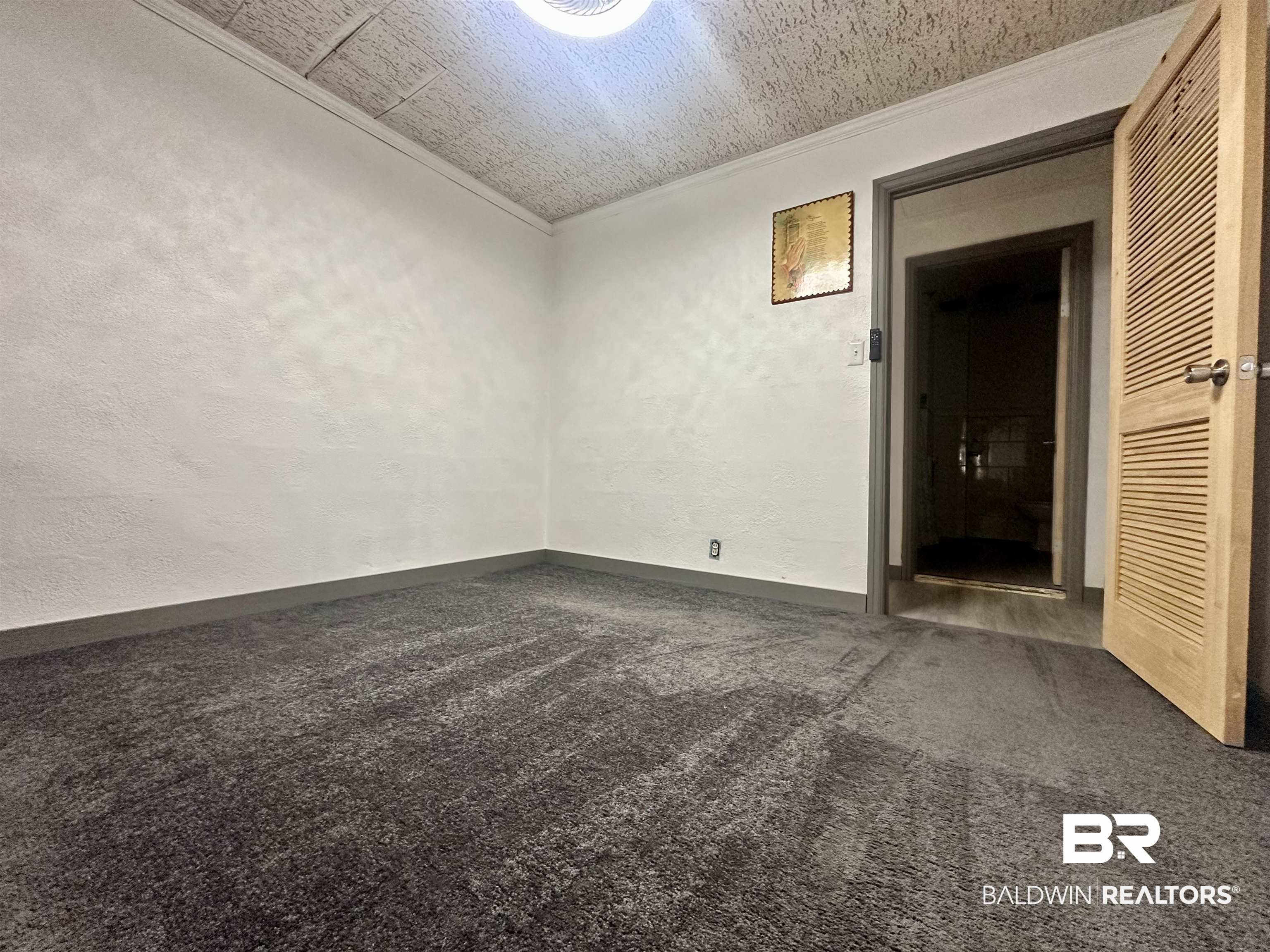1206 St Nicholas Avenue Brewton, AL 36426 - Photo 8 of 19 Empty room with ornamental molding and carpet flooring