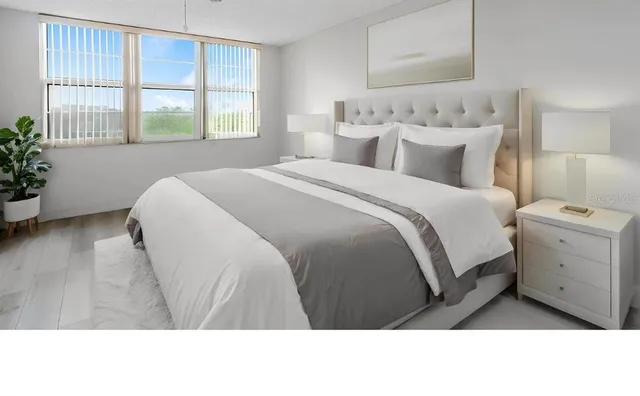 a bedroom with a bed and a window