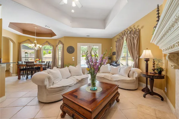 a living room with fireplace furniture and a large window