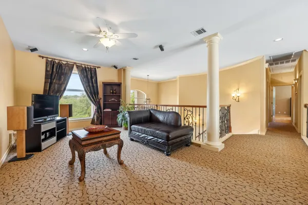a living room with furniture and a chandelier