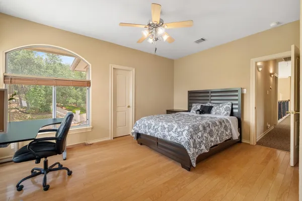 a bedroom with a bed and ceiling fan