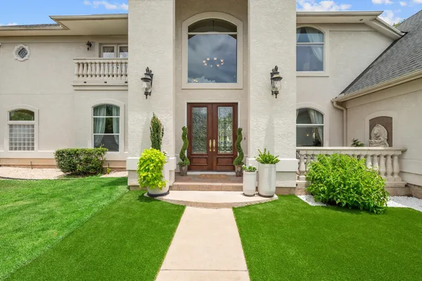 a front view of a house with garden
