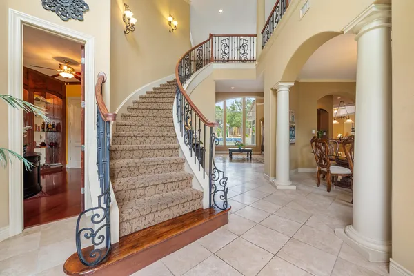 a view of entryway and hall with wooden floor