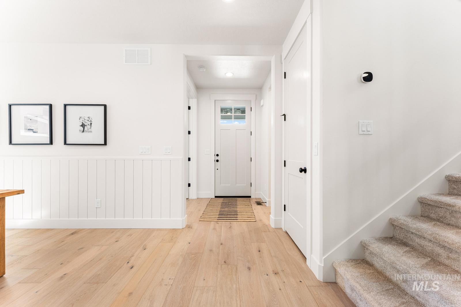13344 North Spring Creek Way Boise, ID 83714 - Photo 13 of 39 Entryway featuring light wood finished floors and a wainscoted wall