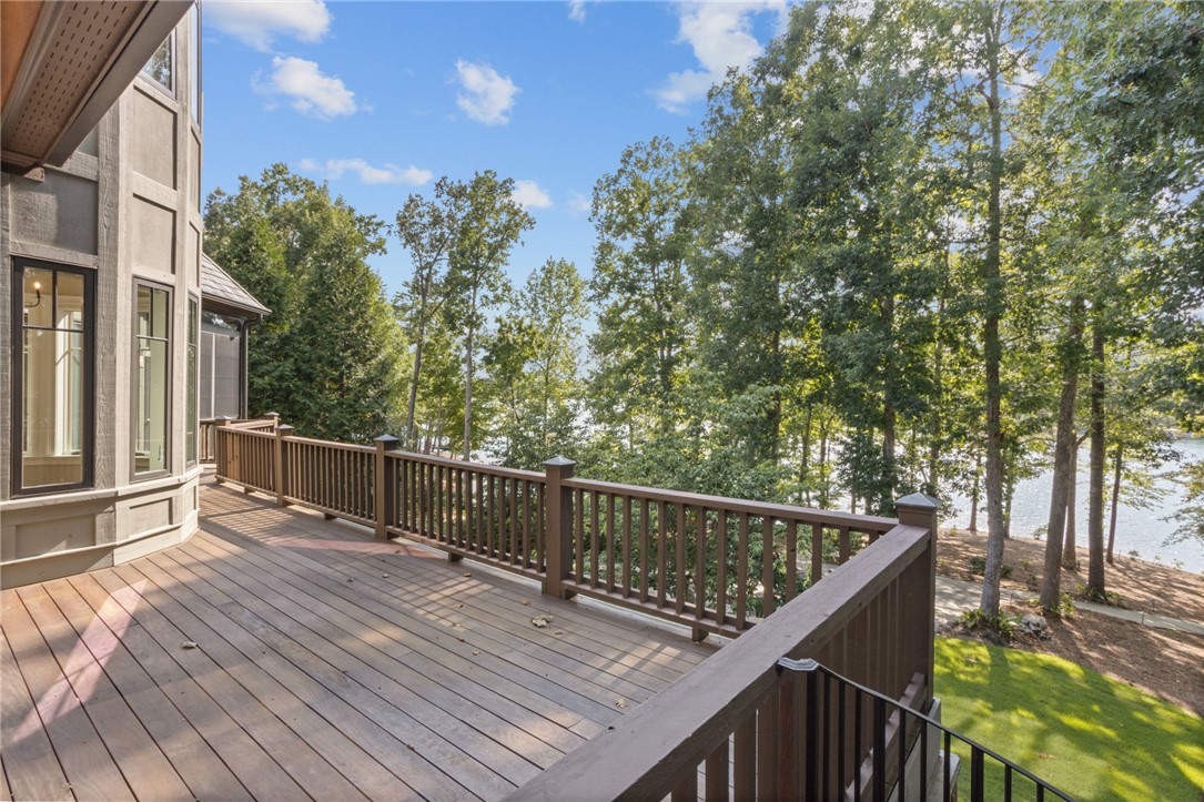 314 Palmer Way Sunset, SC 29685 - Photo 35 of 48 An inviting outdoor deck provides sweeping views of the sparkling lake framed by lush, mature trees.