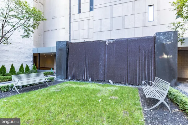 a view of a backyard with potted plants and a bench