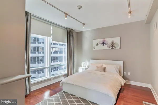 a bedroom with a large bed and a large window