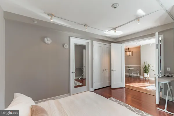 a spacious bedroom with a large bed and a chandelier