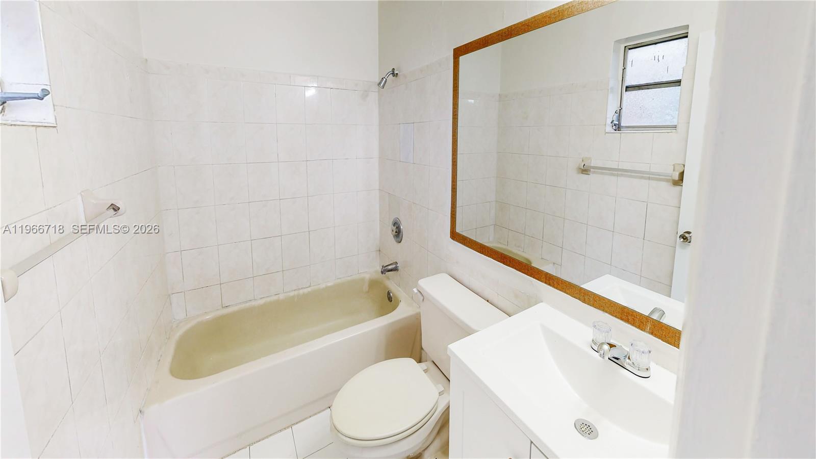 1664 Southwest 2 Court Homestead, FL 33030 - Photo 15 of 57 a bathroom with a white bath tub a toilet and a sink