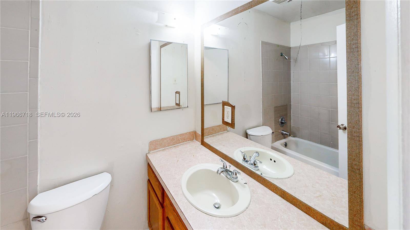 1664 Southwest 2 Court Homestead, FL 33030 - Photo 27 of 57 a bathroom with a granite countertop sink toilet and a mirror