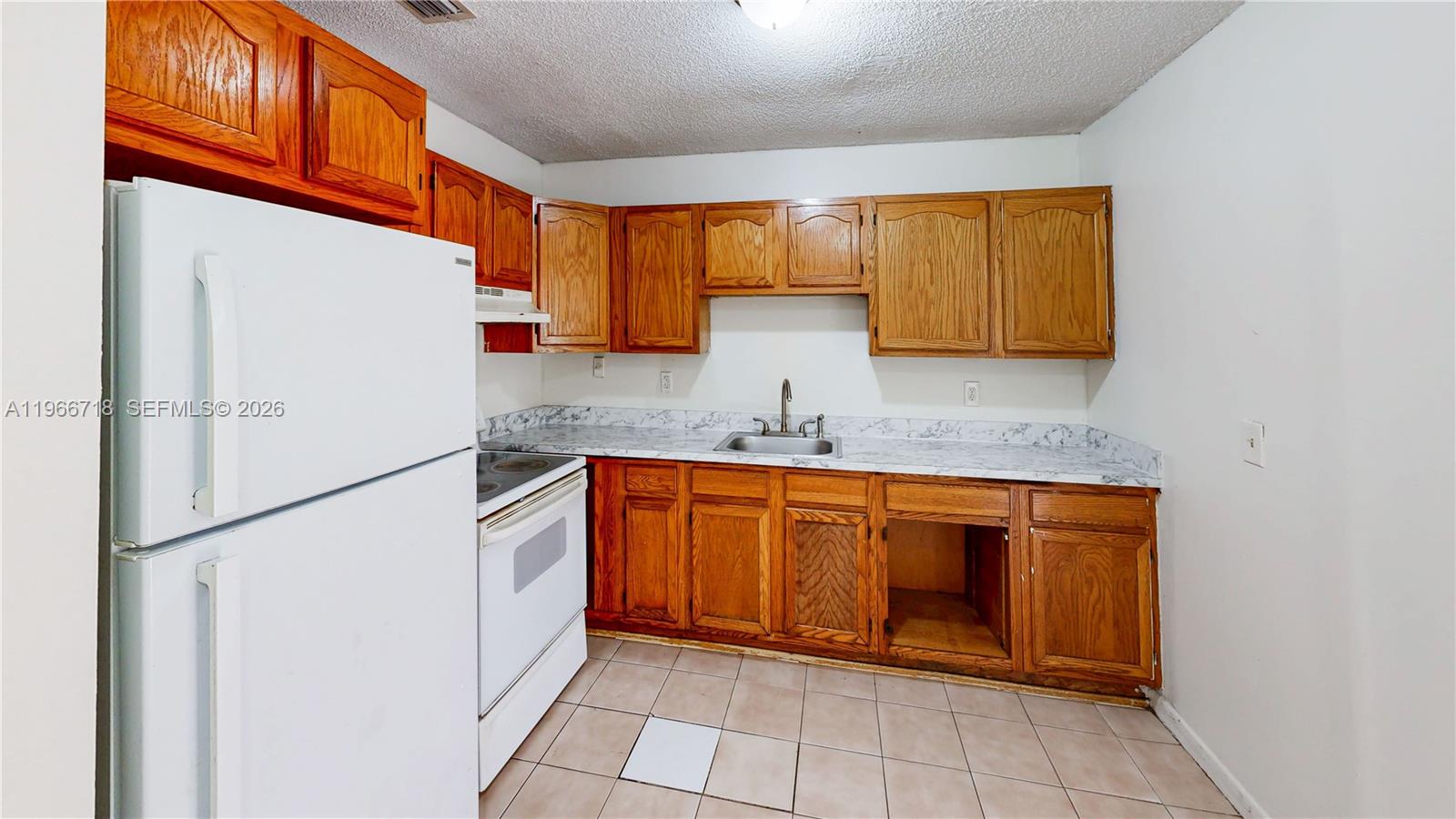 1664 Southwest 2 Court Homestead, FL 33030 - Photo 6 of 57 a kitchen with stainless steel appliances granite countertop a refrigerator and a sink